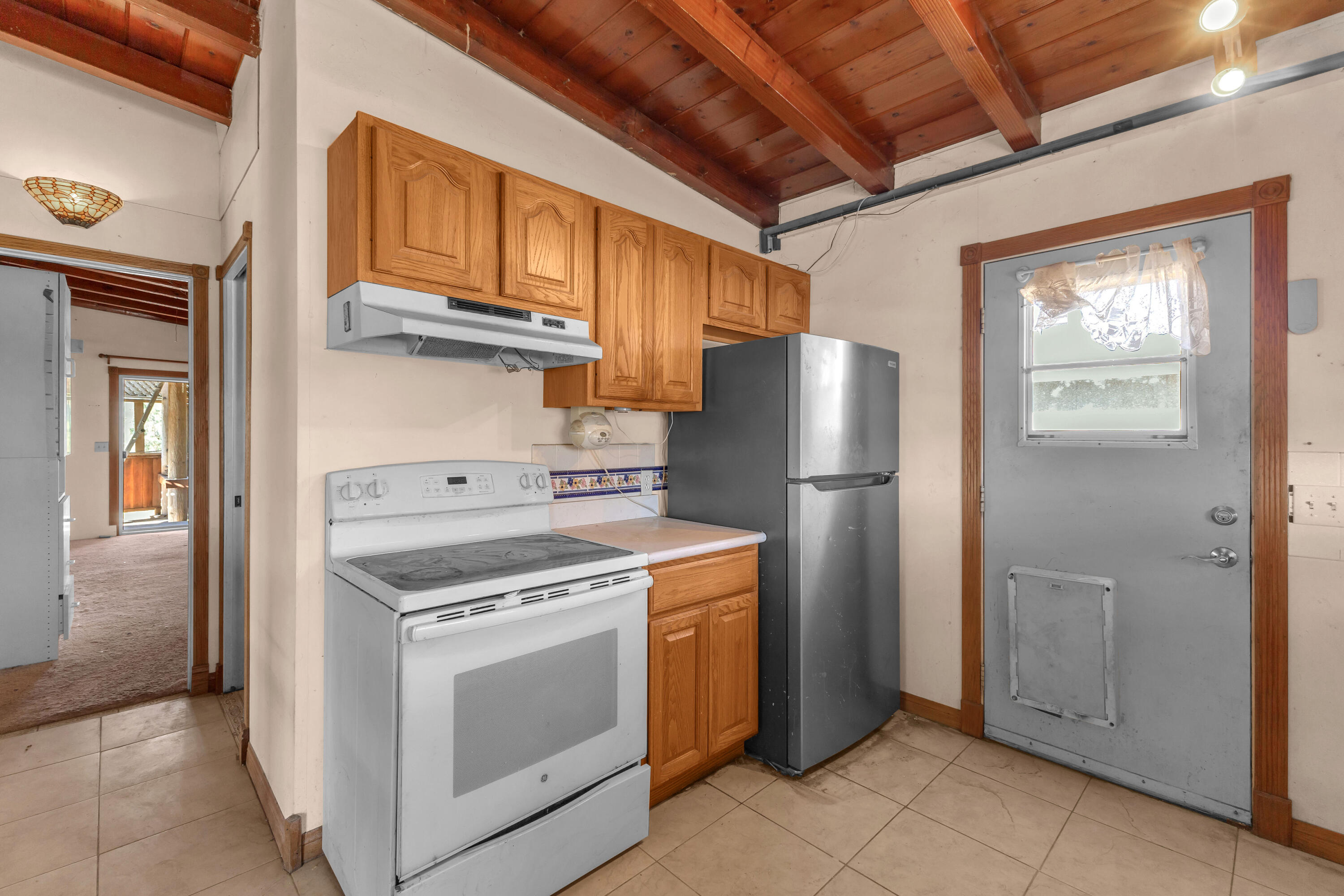 81975 Dillon Road Desert Hot Springs, CA 92241 - Photo 4 of 51 a kitchen with a stove top oven a refrigerator and cabinets