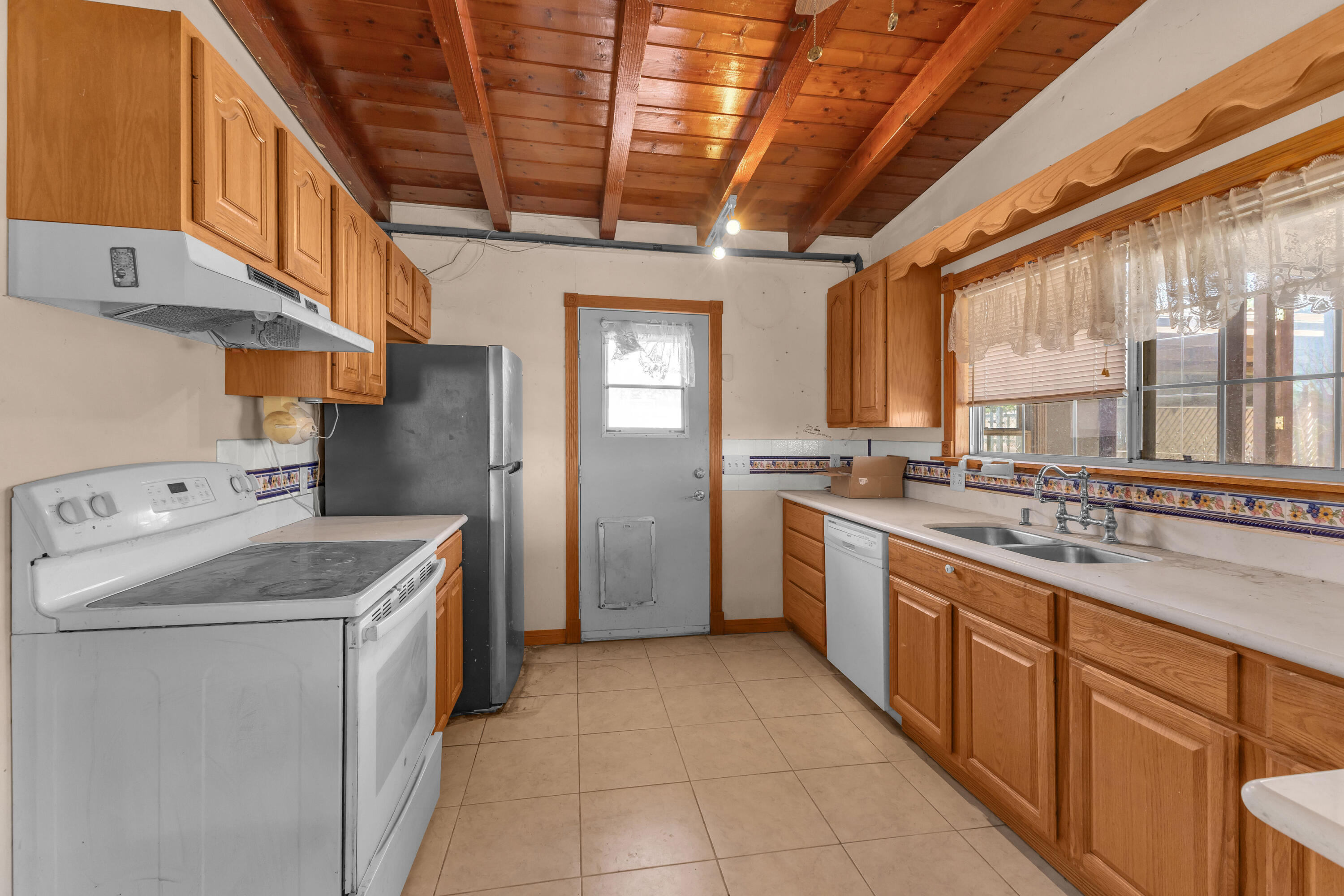 81975 Dillon Road Desert Hot Springs, CA 92241 - Photo 6 of 51 a kitchen with a sink stove and cabinets