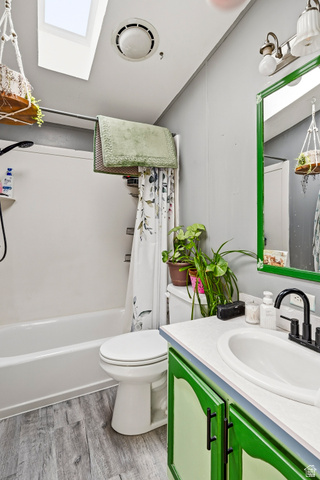 4296 Maple Lane Cedar City, UT 84721 - Photo 26 of 44 Bathroom featuring a tub/shower combination, skylight, and wood-finish flooring