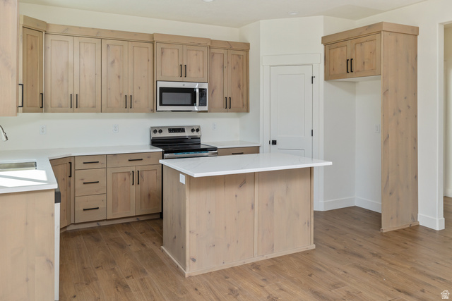 612 North 400 West Logan, UT 84321 - Photo 14 of 27 Contemporary kitchen featuring wood-finish cabinetry and an island with white countertops