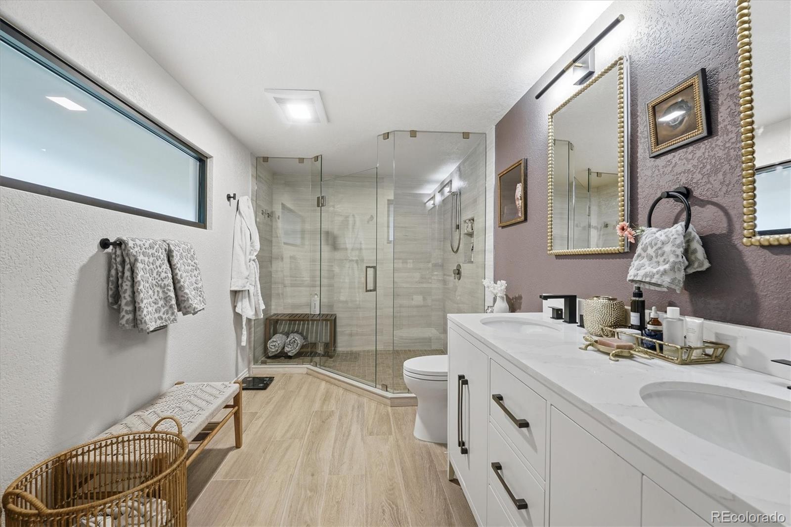 4607 West Wagon Trail Road Littleton, CO 80123 - Photo 29 of 49 a bathroom with a sink a toilet and shower