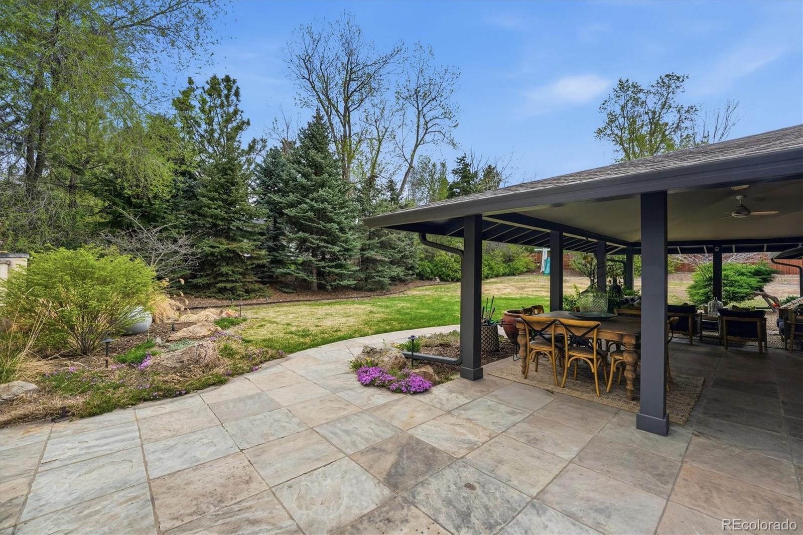 4607 West Wagon Trail Road Littleton, CO 80123 - Photo 43 of 49 a view of a patio with a table and chairs under an umbrella