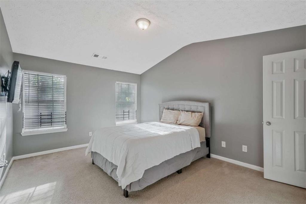 2870 Vining Ridge Terrace Decatur, GA 30034 - Photo 15 of 23 a bed sitting in a spacious bedroom next to a window and a dresser