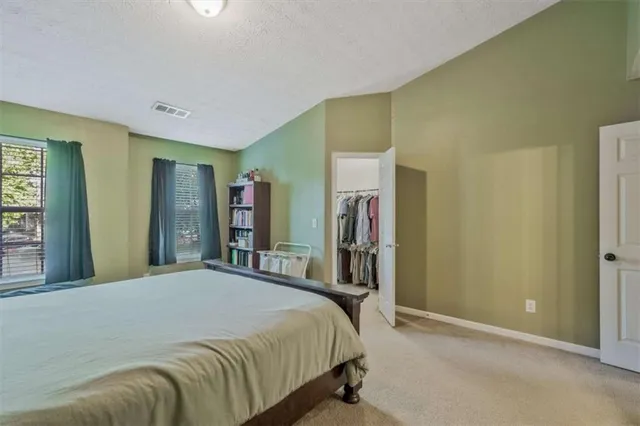 a bedroom with a bed and a large mirror