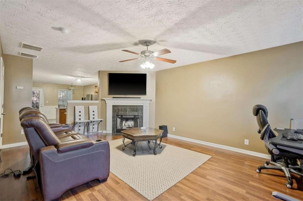 2870 Vining Ridge Terrace Decatur, GA 30034 - Photo 5 of 23 a living room with furniture a fireplace and a flat screen tv