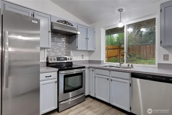 a kitchen with a stove and a sink