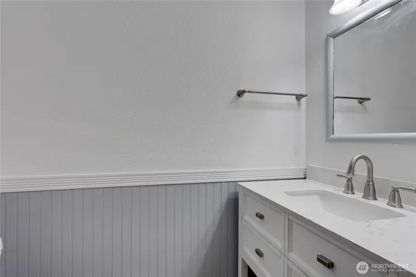 a bathroom with a sink and mirror