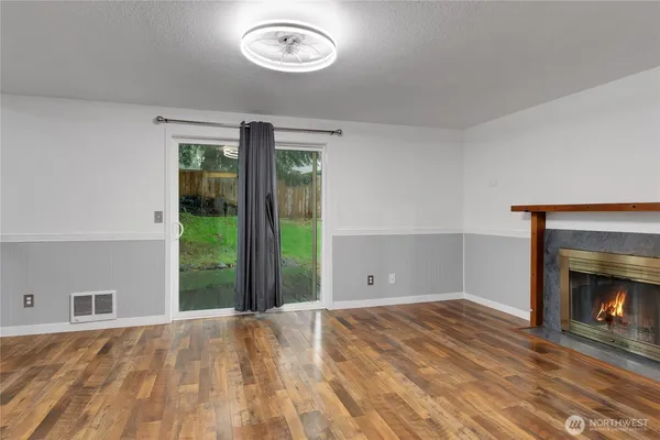 a view of empty room with window and fireplace