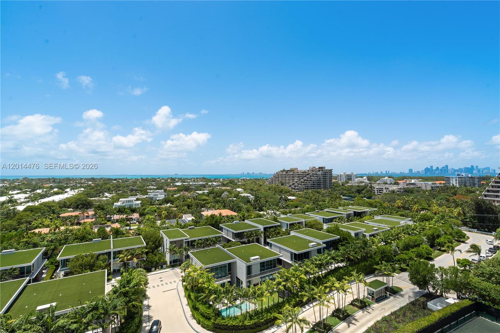 360 Ocean Drive, Unit 1106S Key Biscayne, FL 33149 - Photo 21 of 67 Balcony View – This view captures the home’s elevated outlook from the balcony, with sparkling water, lush greenery, and distant skyline views visible beyond the residence.