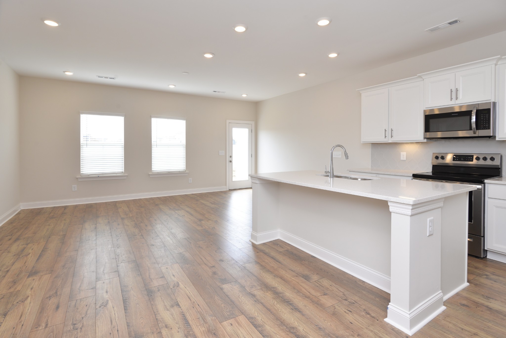 5718 Dockside Rockvale, TN 37153 - Photo 4 of 13 a kitchen with stainless steel appliances granite countertop a stove a sink and white cabinets with wooden floor