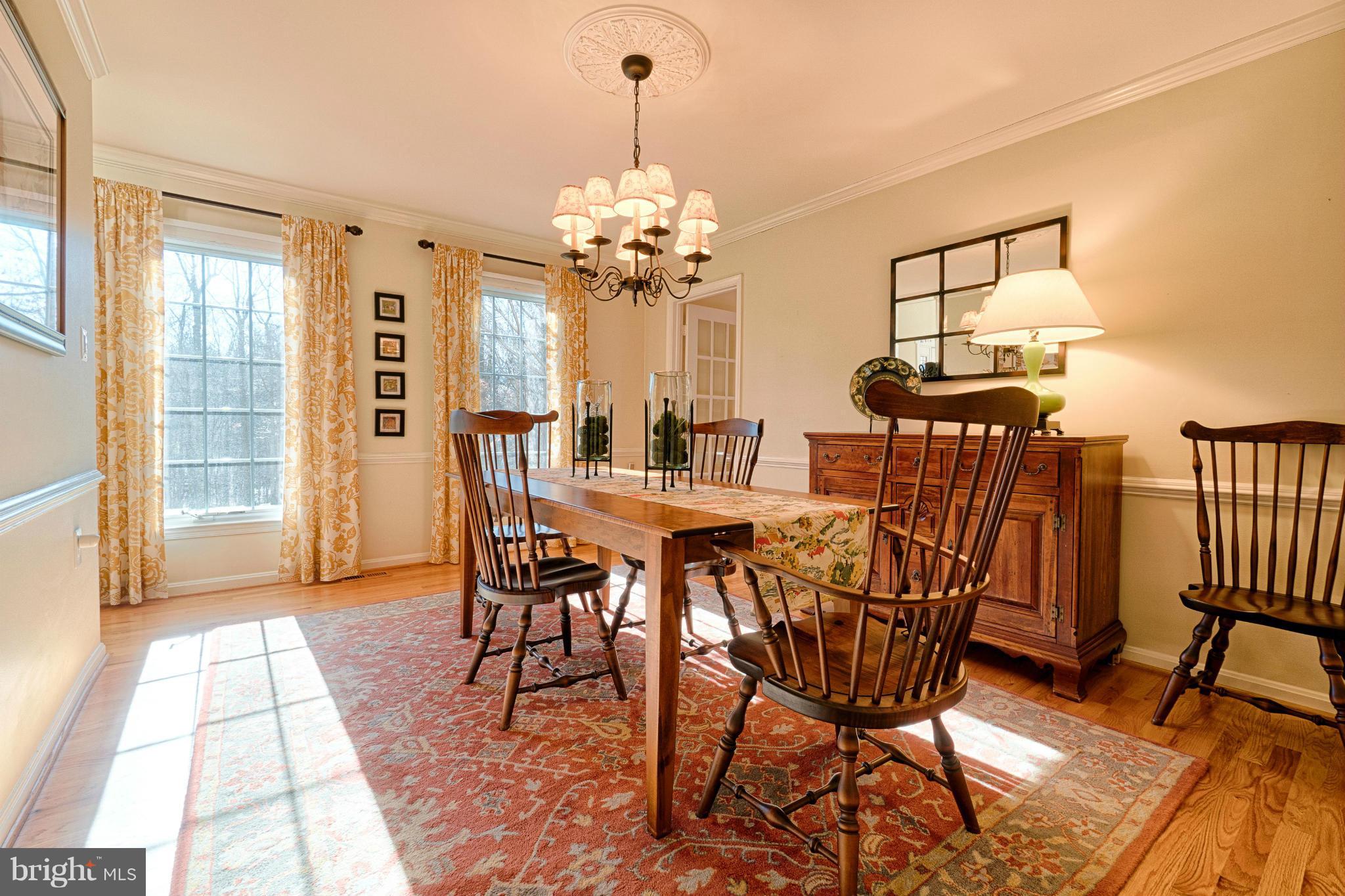 11008 Raccoon Ridge Court Reston, VA 20191 - Photo 18 of 30 a dining room with furniture a chandelier and wooden floor
