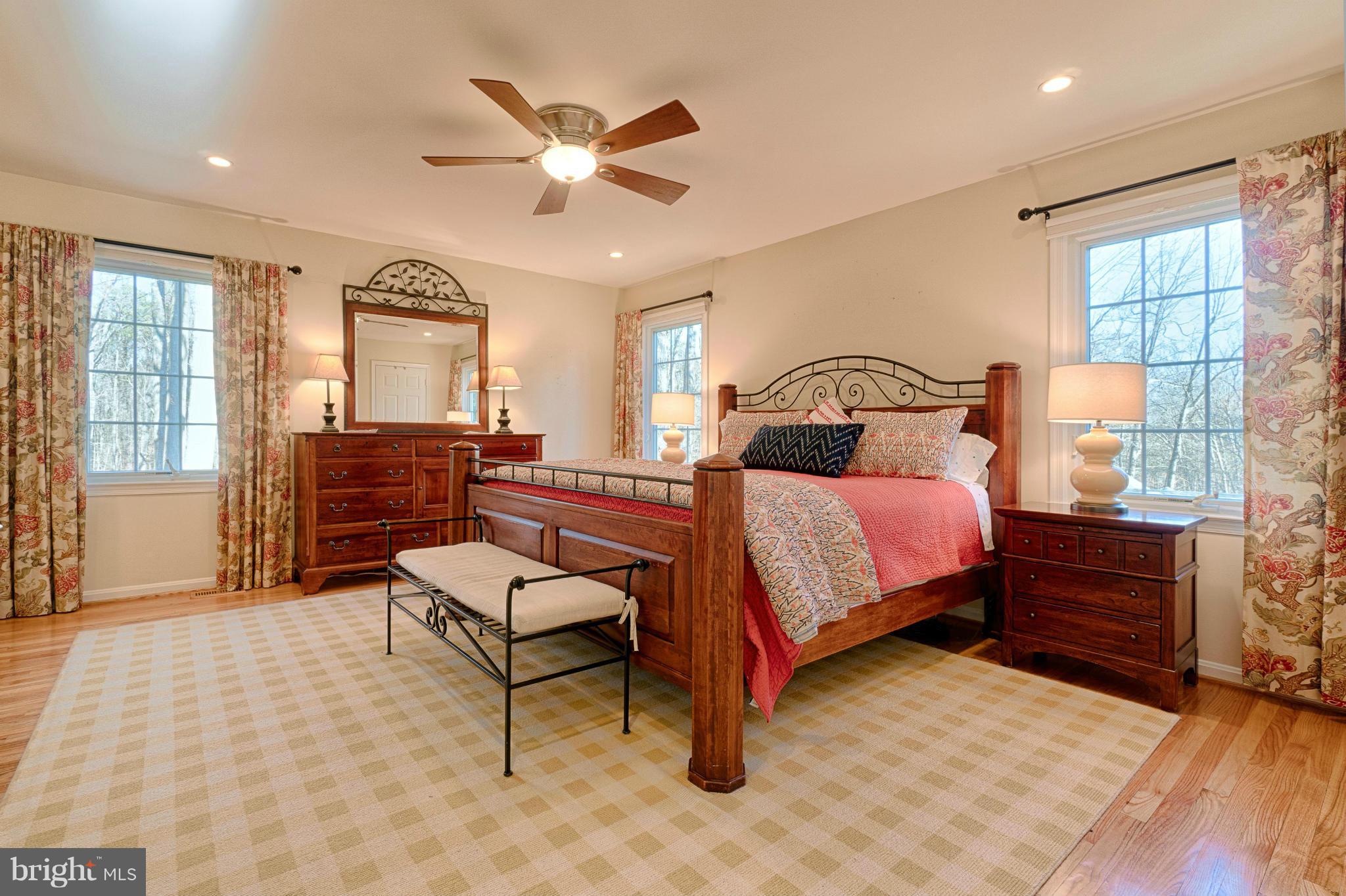 11008 Raccoon Ridge Court Reston, VA 20191 - Photo 22 of 30 a bedroom with a bed and wooden floor
