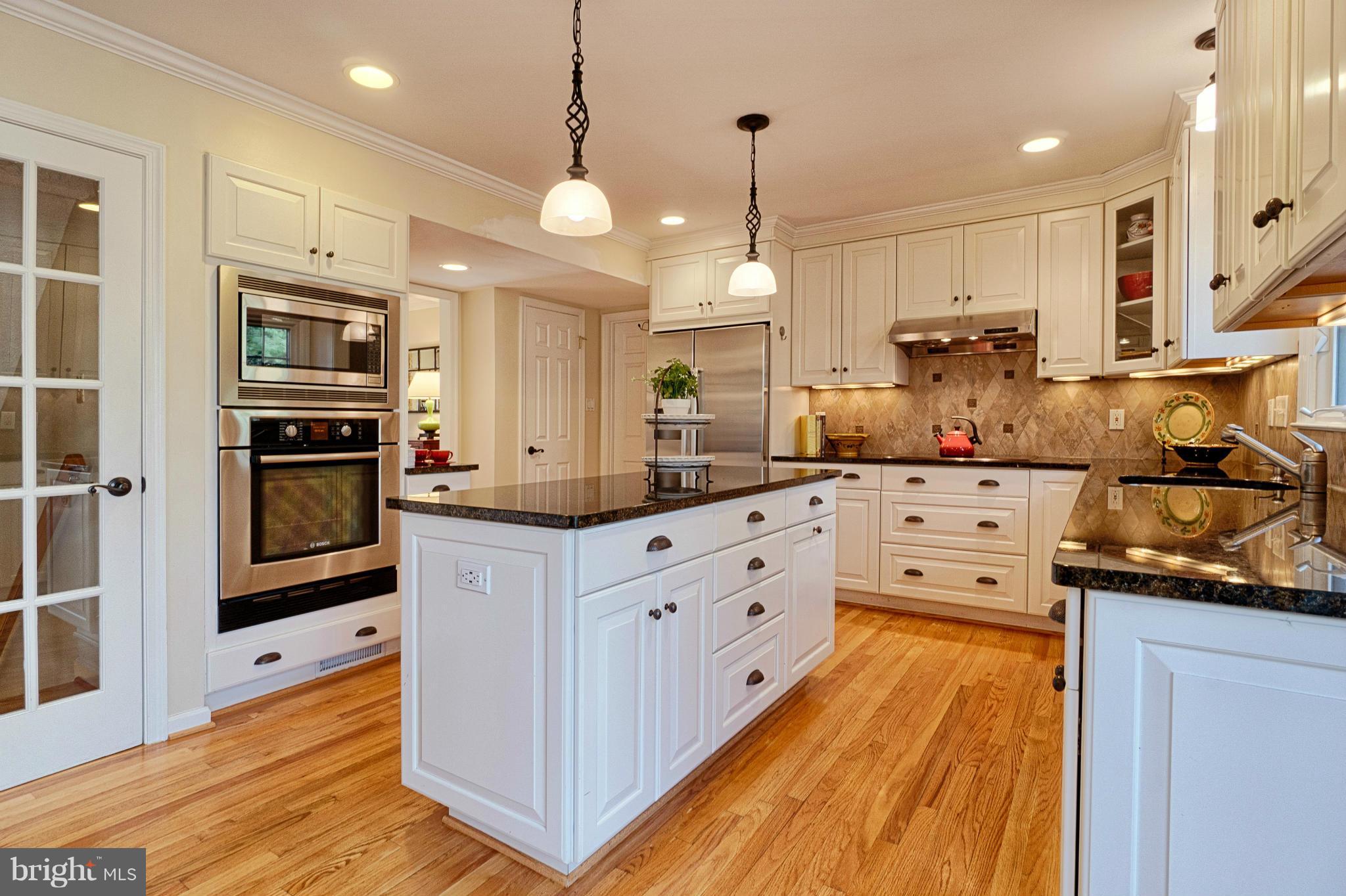 11008 Raccoon Ridge Court Reston, VA 20191 - Photo 10 of 30 a kitchen with stainless steel appliances kitchen island granite countertop a stove a sink and a refrigerator