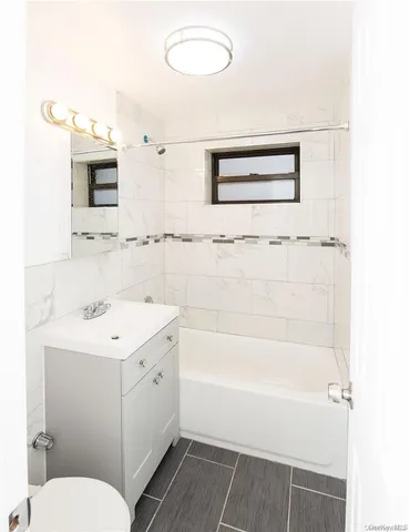 a view of a room with wooden floor and bathroom