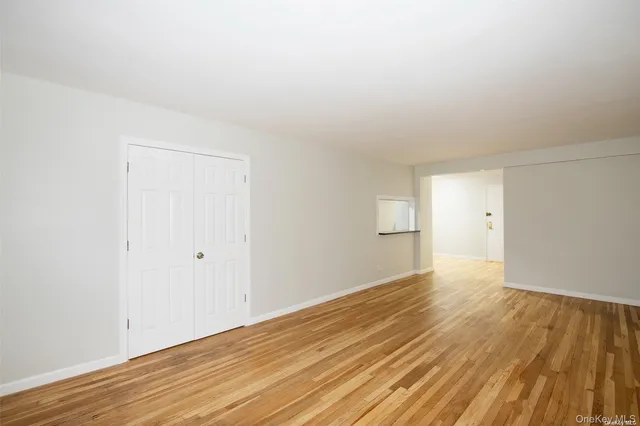 a view of an empty room and wooden floor