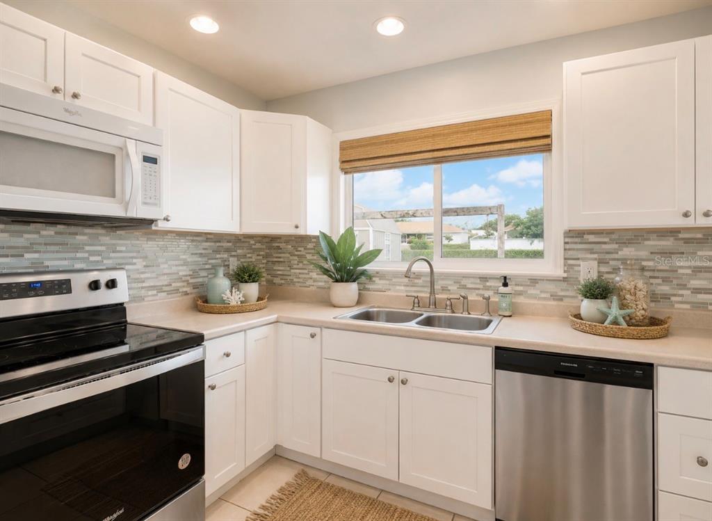 2755 Greendale Road North Port, FL 34287 - Photo 5 of 43 a kitchen with a sink stove and cabinets
