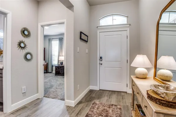 a view of a hallway and wooden floor with closet