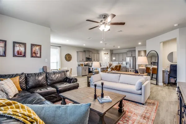 a living room with furniture and view of kitchen