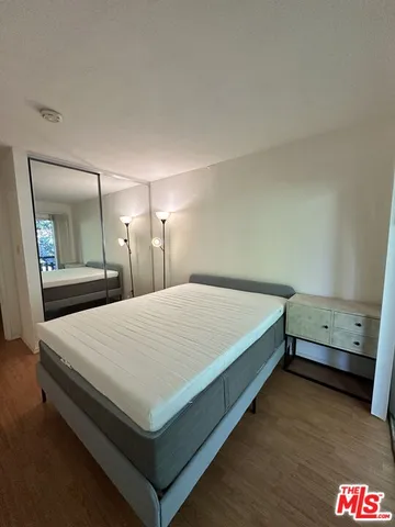 a bedroom with a bed and a mirror