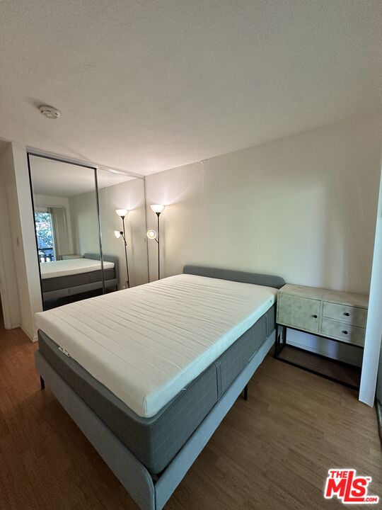 2 Panoramic Way, Unit 302 Berkeley, CA 94704 - Photo 8 of 16 a bedroom with a bed and a mirror