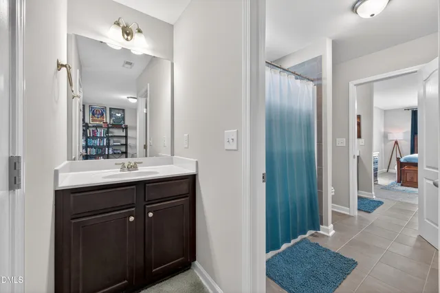 an aerial view of a house with swimming pool and large trees