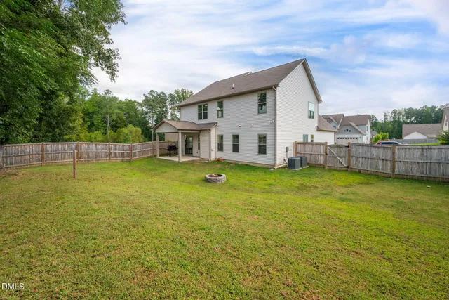 a view of a white house with a swimming pool