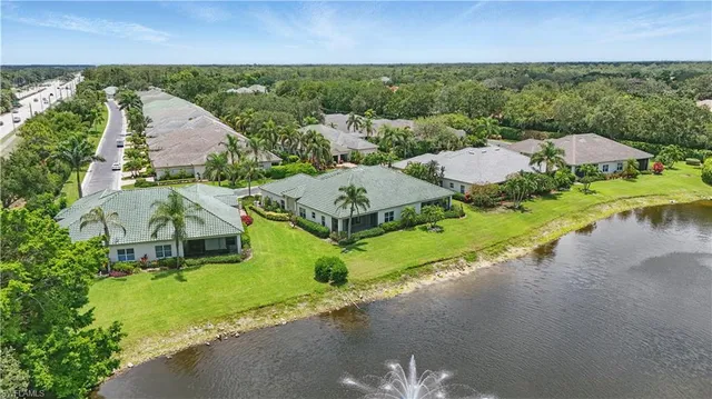an aerial view of a house with a garden and lake view