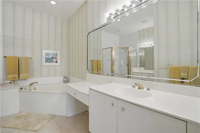 a bathroom with a double vanity sink toilet and shower
