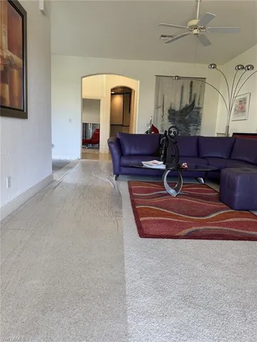 a living room with couch chairs and a stove