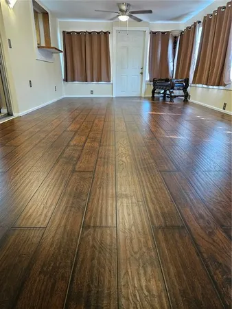 a view of a room with wooden floor and chair