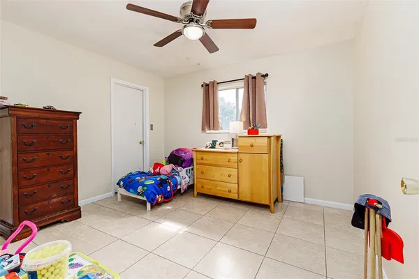 a living room with furniture and a baby crib