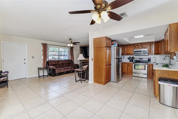 a kitchen with stainless steel appliances kitchen island granite countertop a refrigerator and microwave