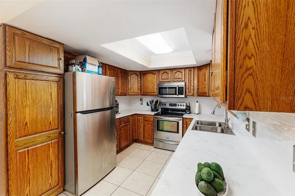 a kitchen with stainless steel appliances a refrigerator sink and stove