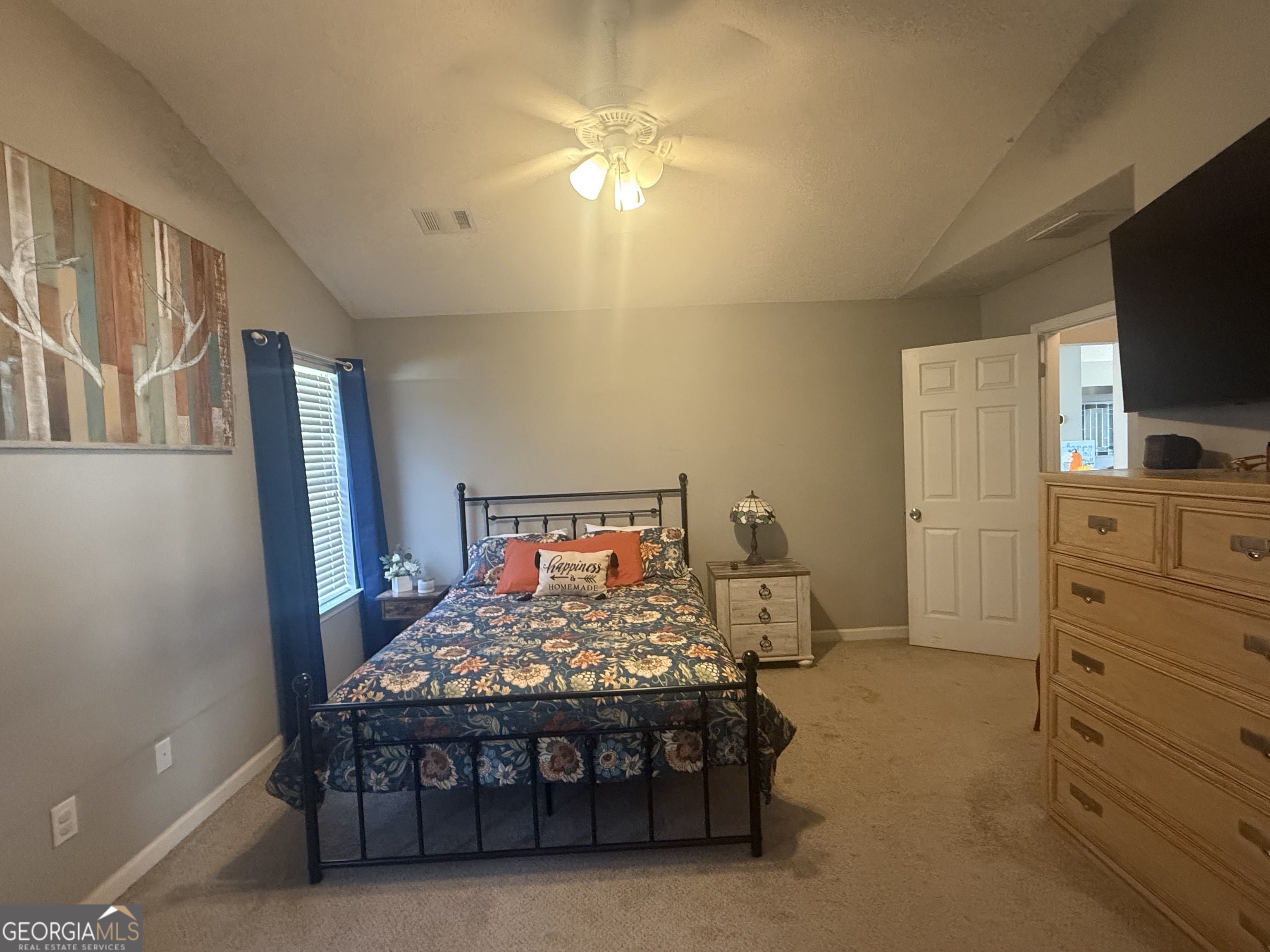 340 Harris Avenue Locust Grove, GA 30248 - Photo 12 of 24 a bedroom with a bed and a flat screen tv