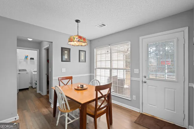 a kitchen with granite countertop a refrigerator stove top oven and sink