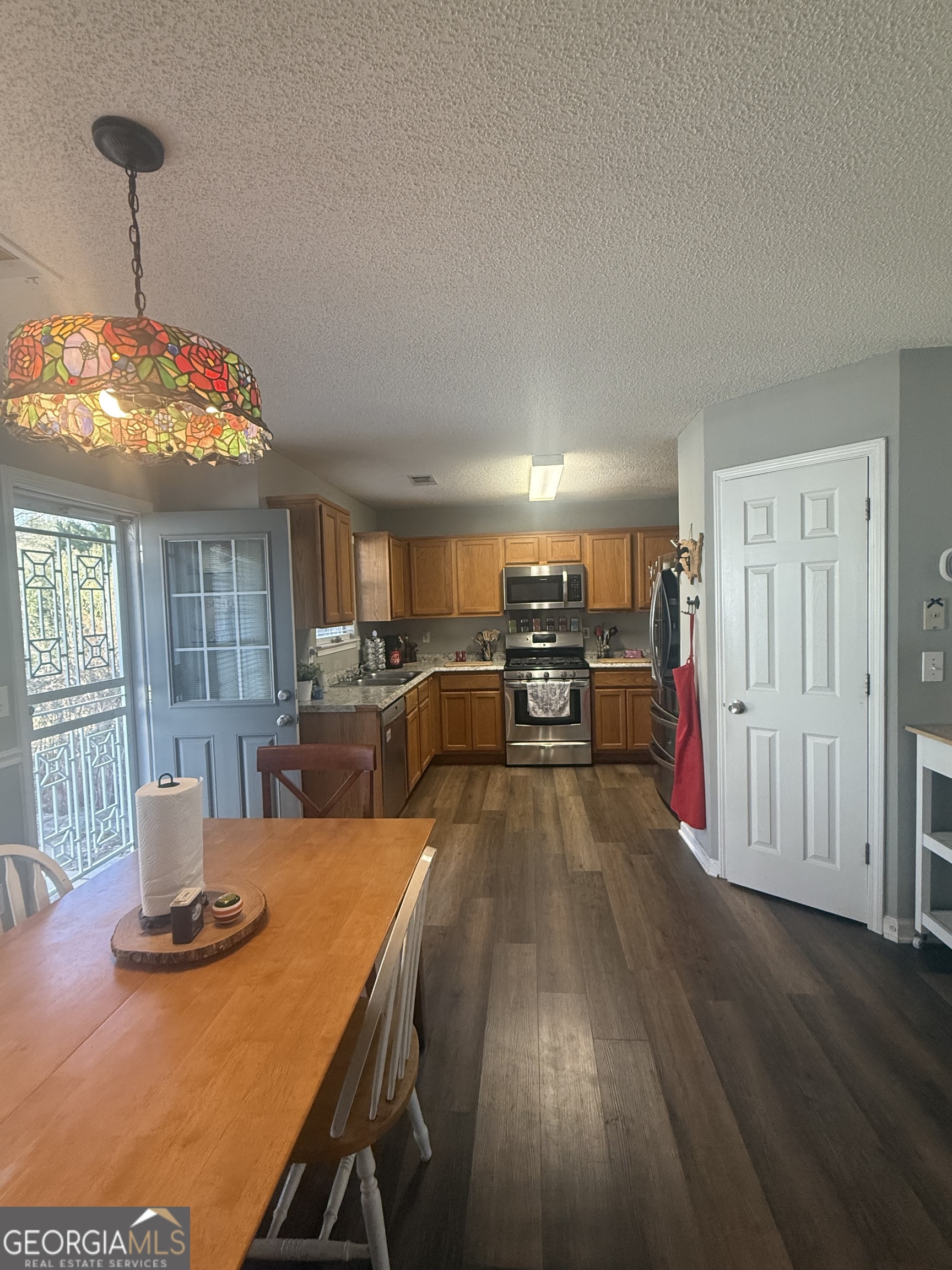 340 Harris Avenue Locust Grove, GA 30248 - Photo 13 of 24 a view of a dining room with furniture window and wooden floor