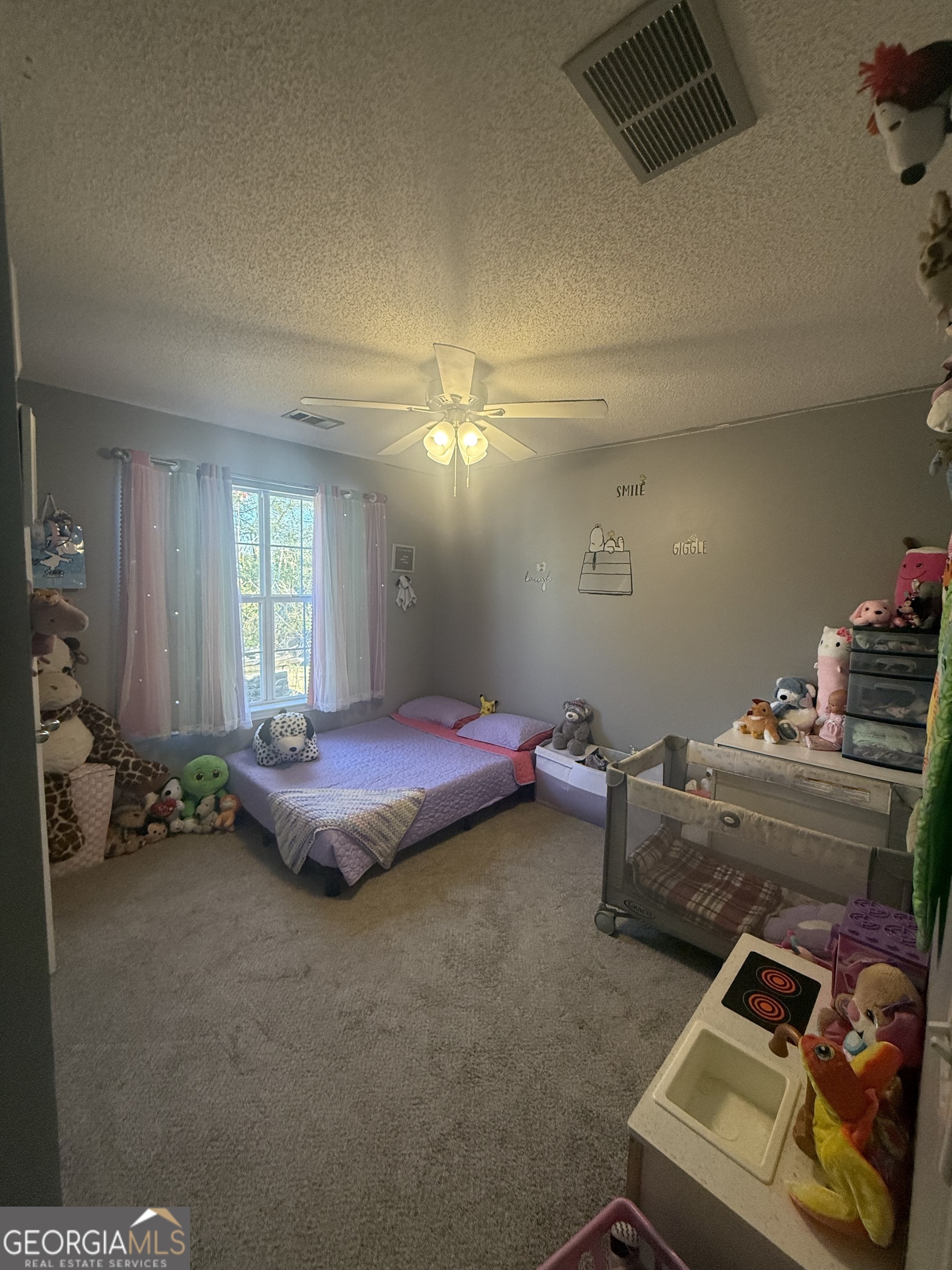 340 Harris Avenue Locust Grove, GA 30248 - Photo 17 of 24 a bedroom with furniture and a window