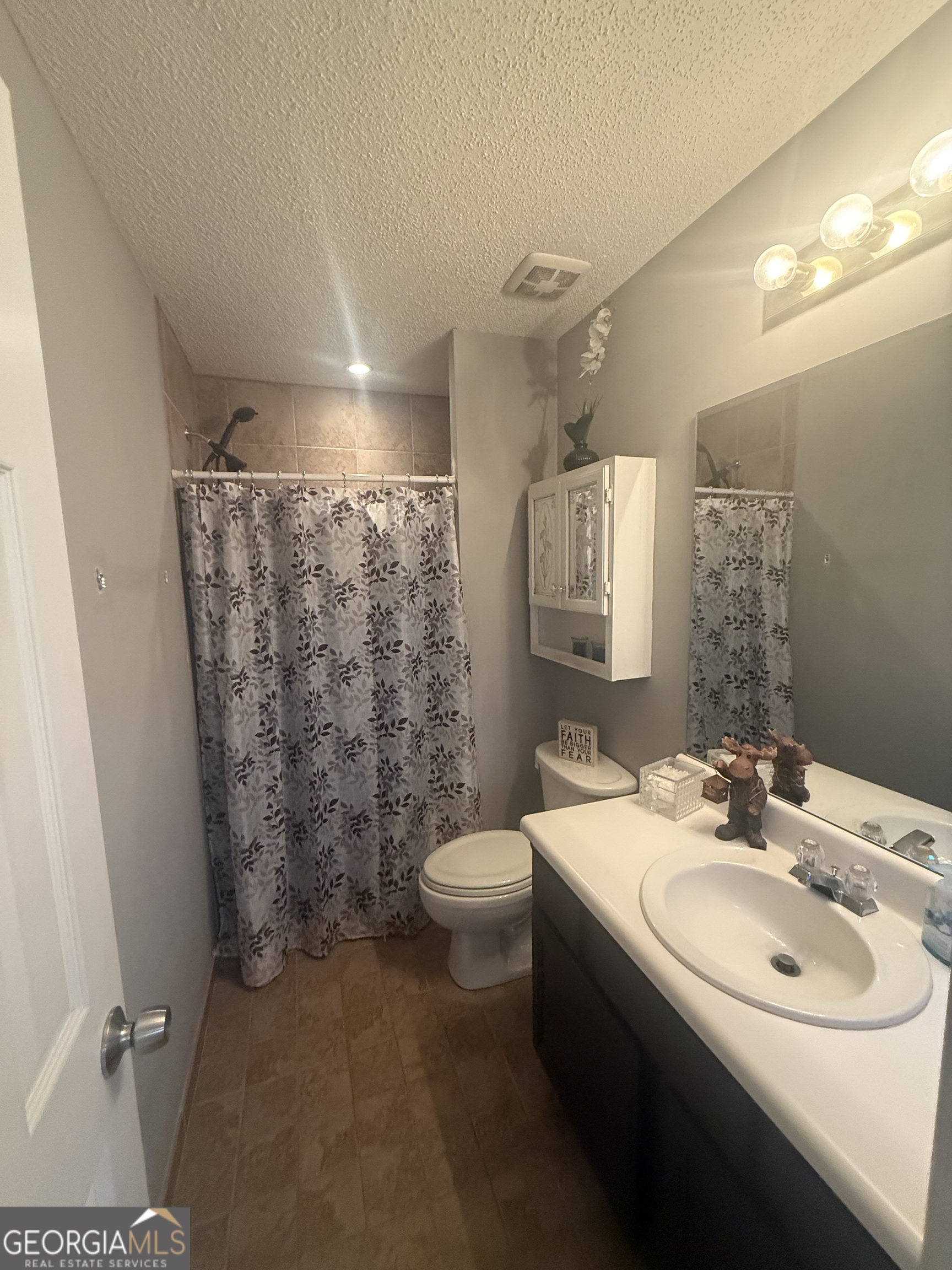 340 Harris Avenue Locust Grove, GA 30248 - Photo 18 of 24 a bathroom with a sink toilet and shower