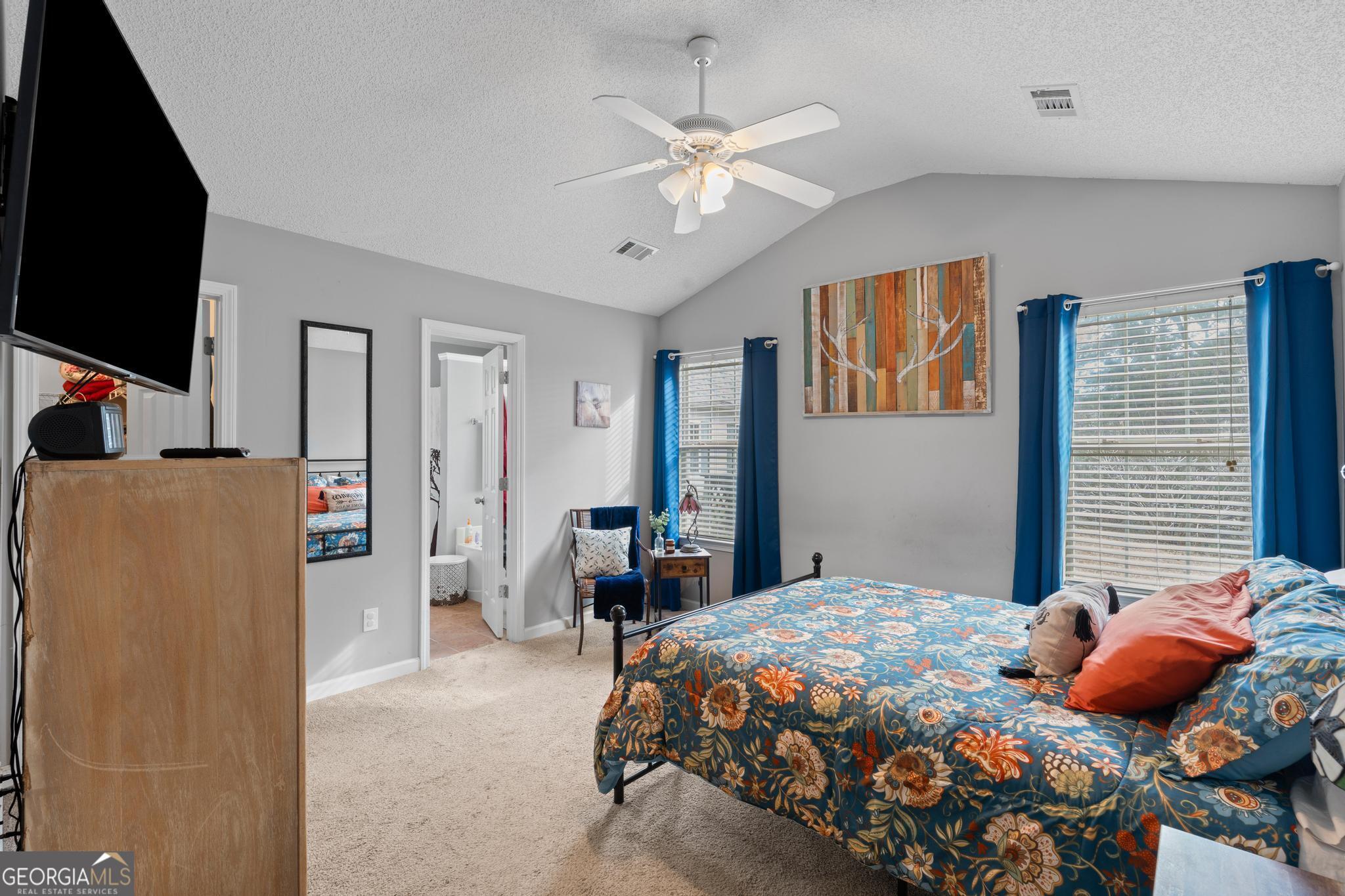 340 Harris Avenue Locust Grove, GA 30248 - Photo 20 of 41 a bedroom with a bed and a chandelier