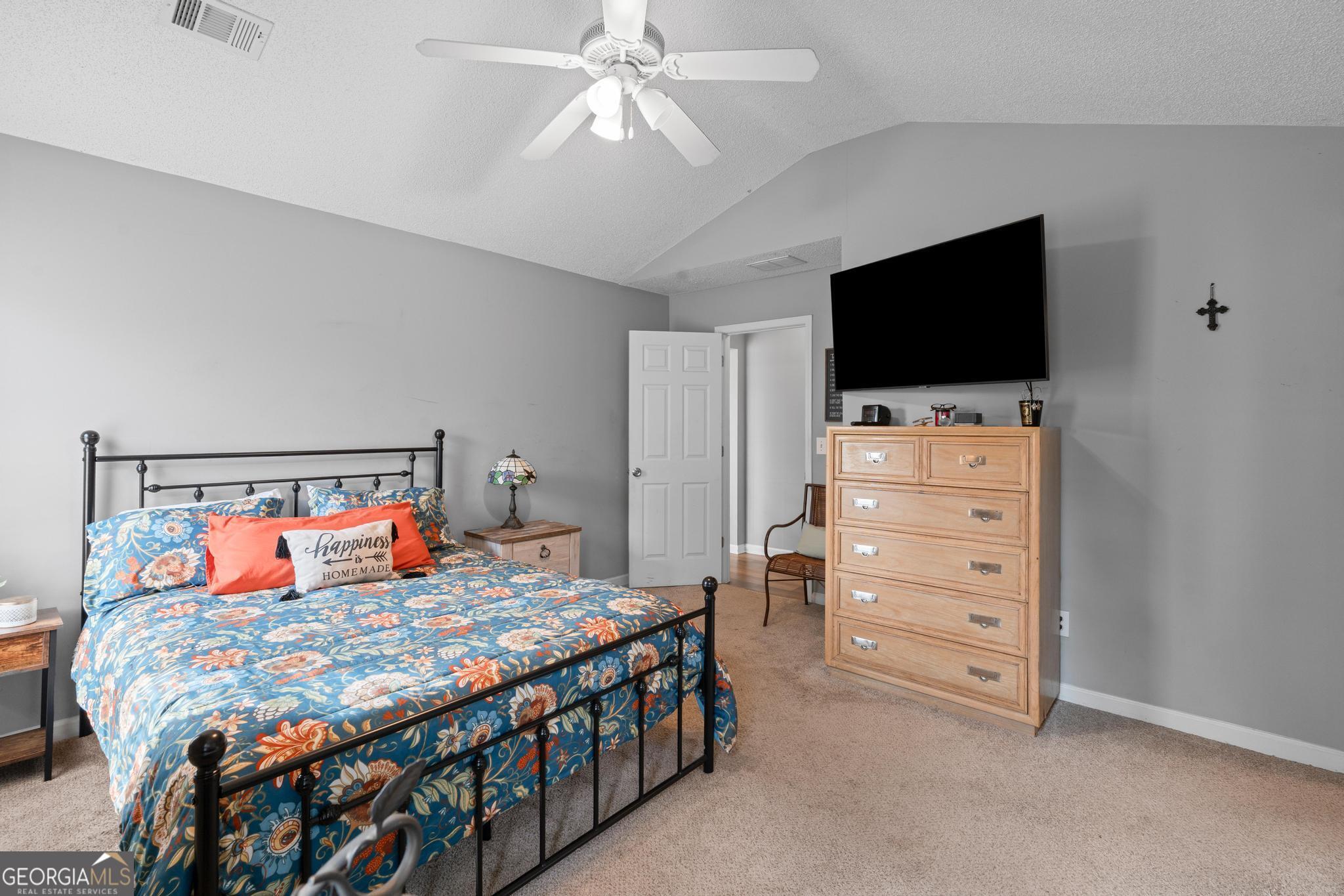 340 Harris Avenue Locust Grove, GA 30248 - Photo 21 of 41 a bedroom with a bed and a flat screen tv