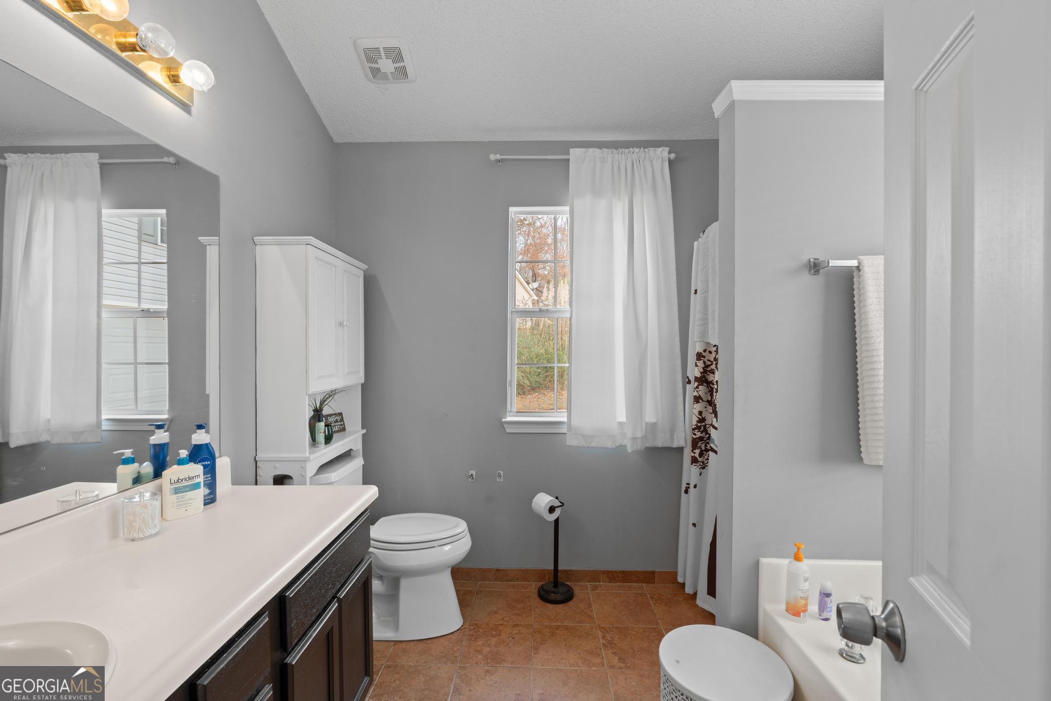 340 Harris Avenue Locust Grove, GA 30248 - Photo 24 of 41 a bathroom with a sink toilet tub and shower