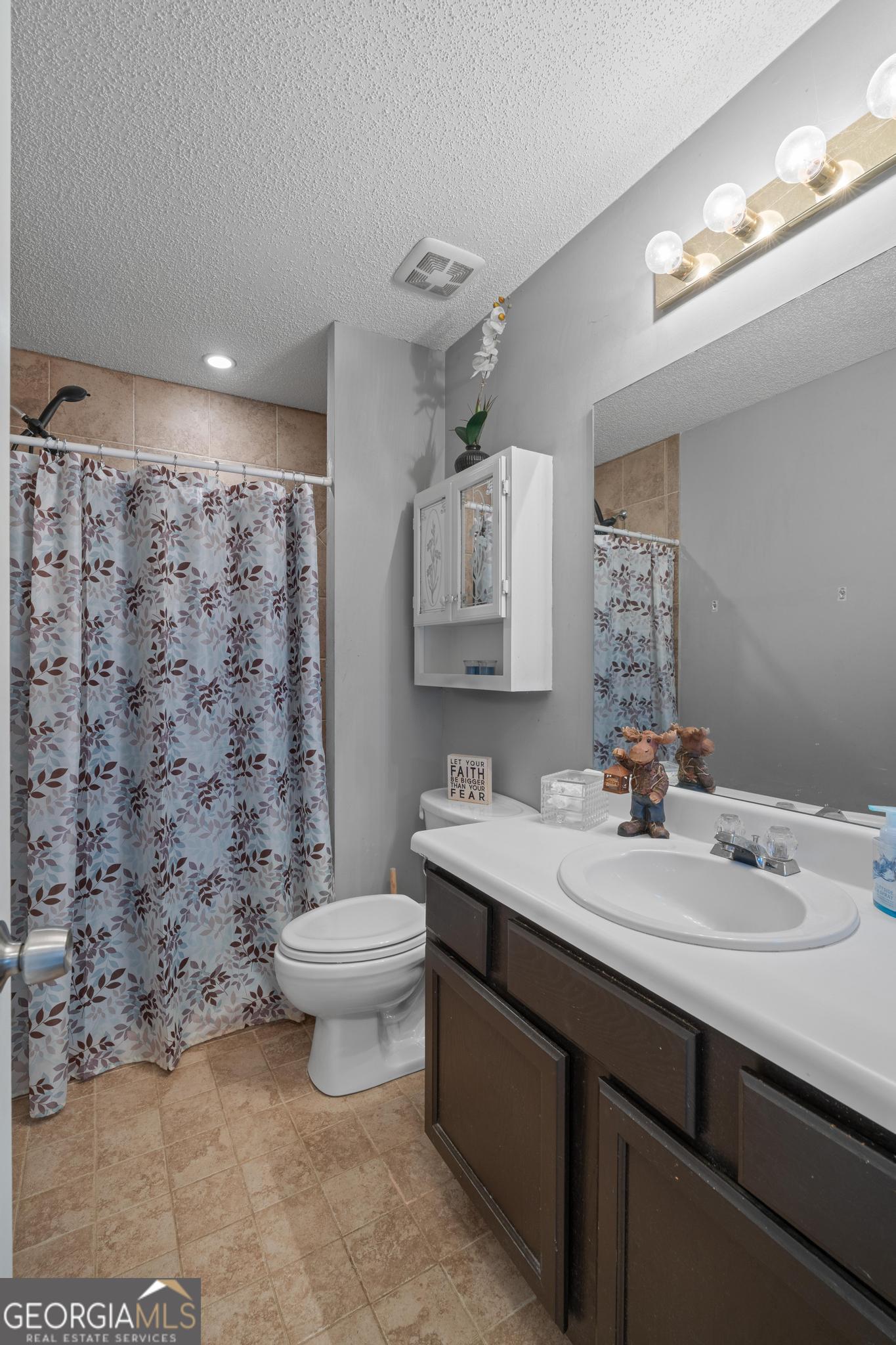 340 Harris Avenue Locust Grove, GA 30248 - Photo 29 of 41 a bathroom with a sink a toilet and mirror