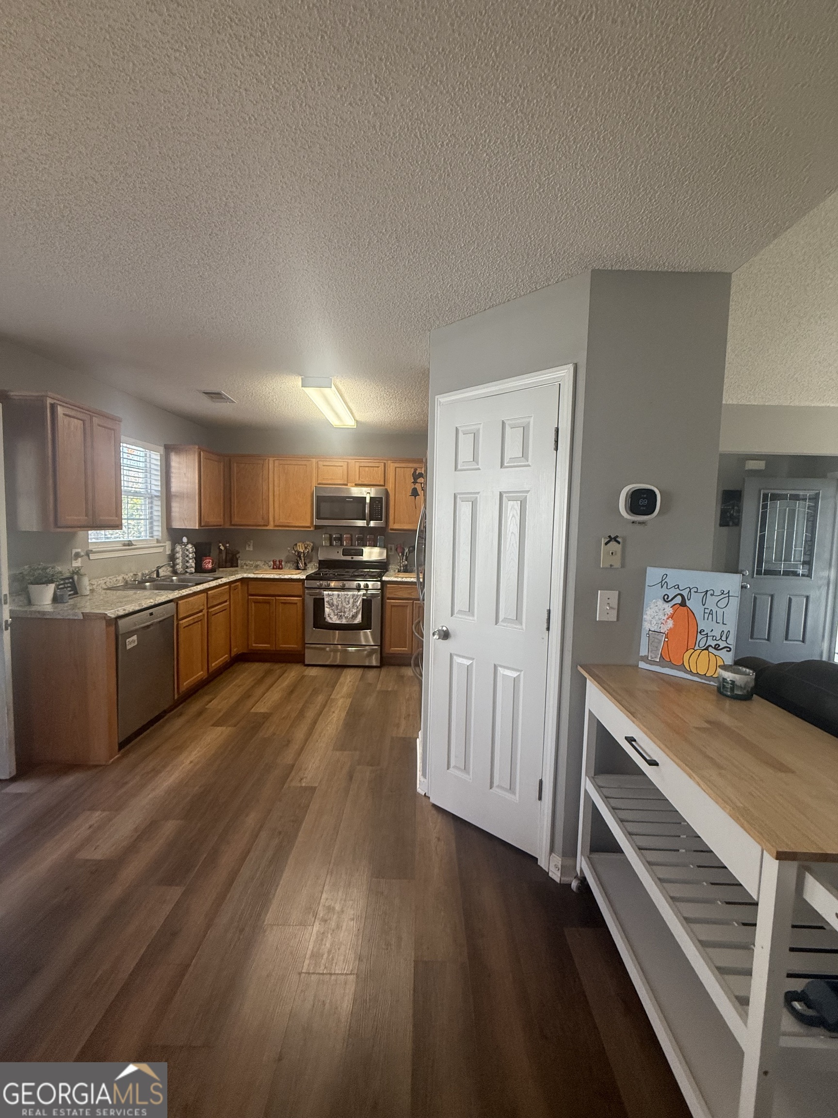 340 Harris Avenue Locust Grove, GA 30248 - Photo 3 of 24 a kitchen with stainless steel appliances a refrigerator and a stove top oven