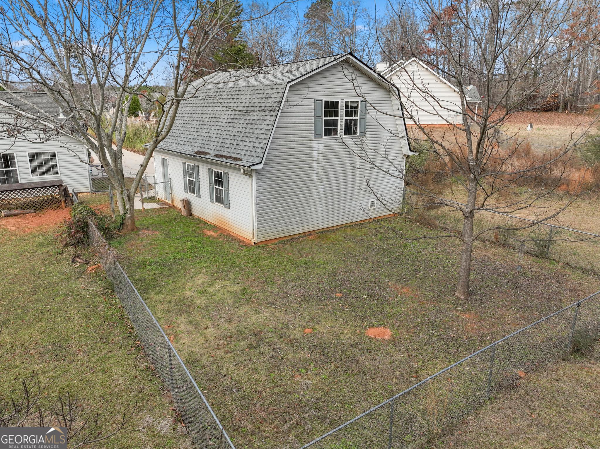 340 Harris Avenue Locust Grove, GA 30248 - Photo 39 of 41 a view of a white house with a yard