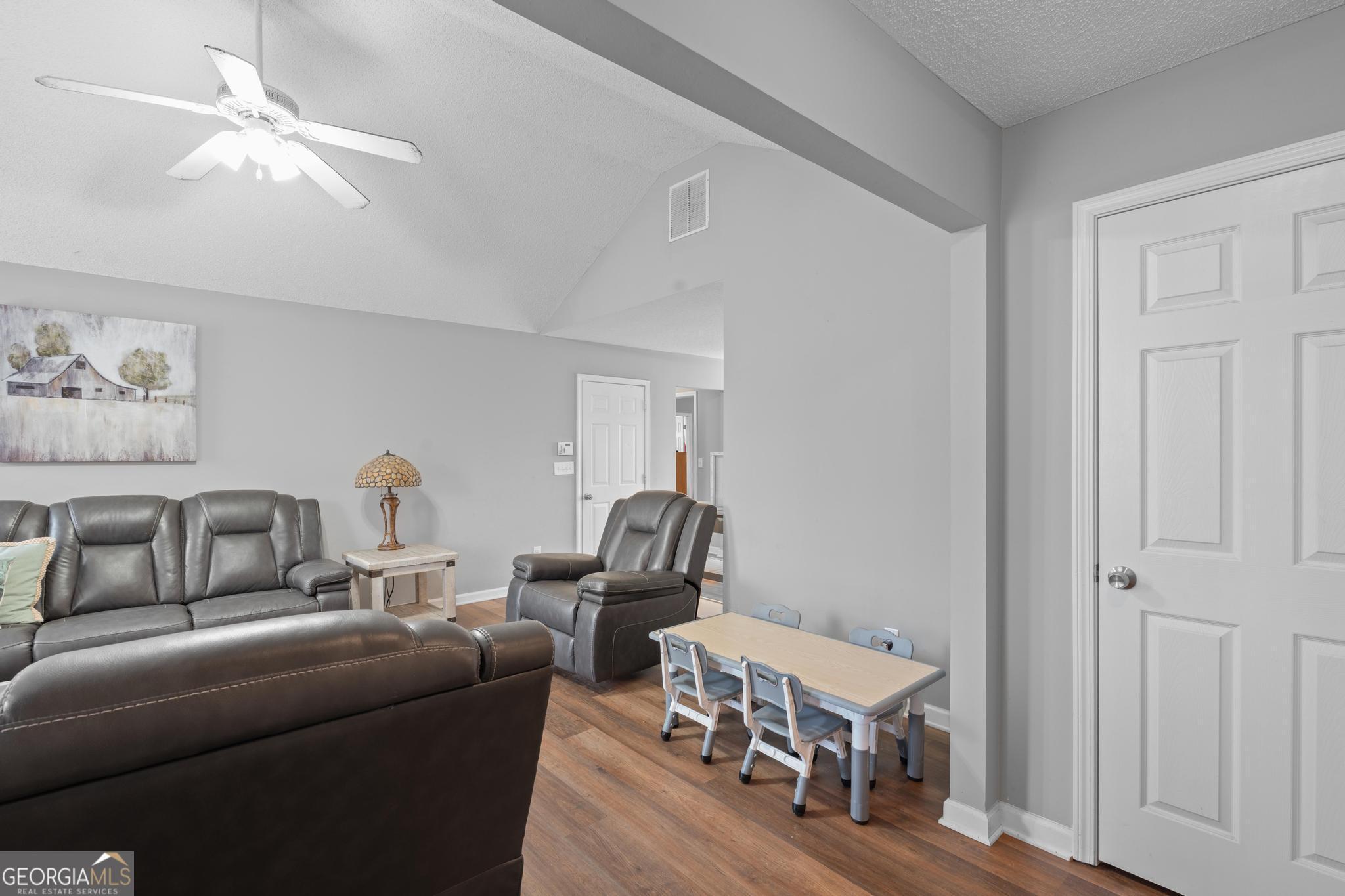 340 Harris Avenue Locust Grove, GA 30248 - Photo 6 of 41 a living room with furniture and a wooden floor