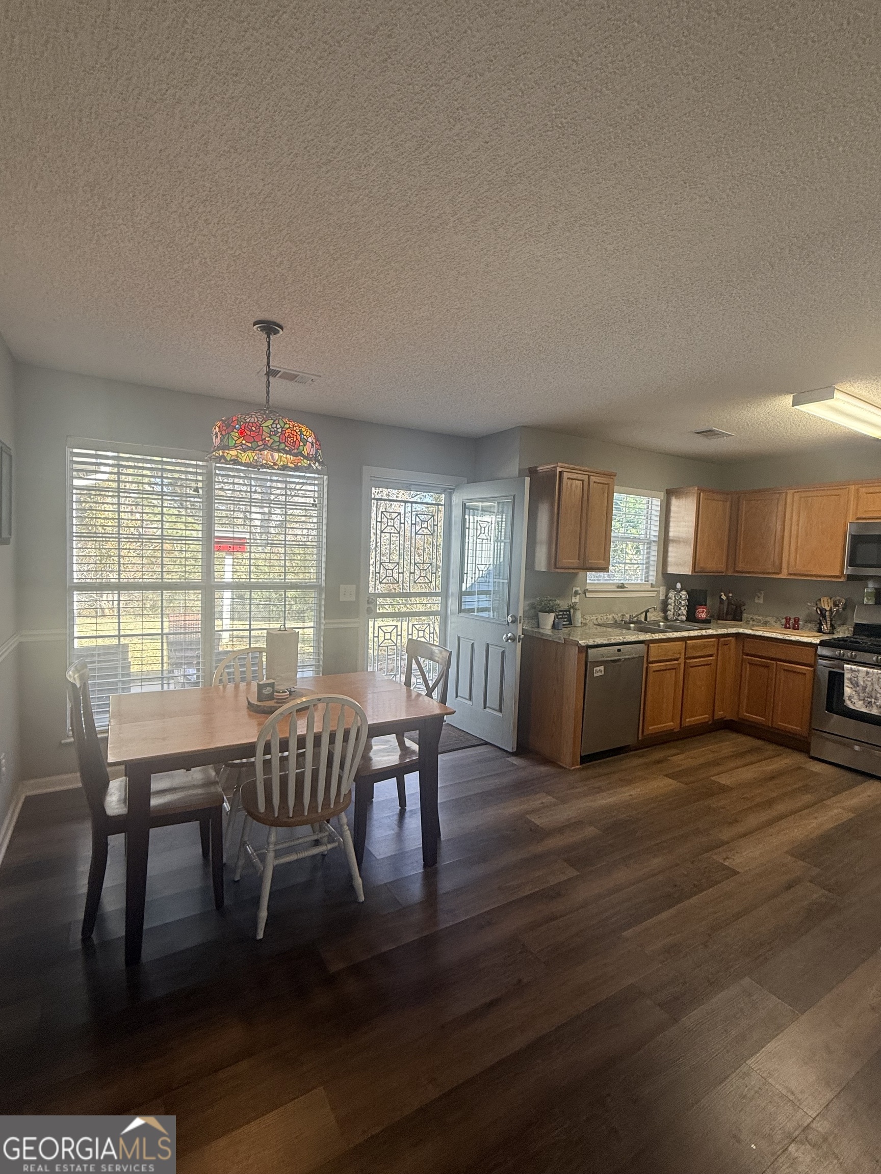340 Harris Avenue Locust Grove, GA 30248 - Photo 6 of 24 a view of a dining room with furniture and wooden floor