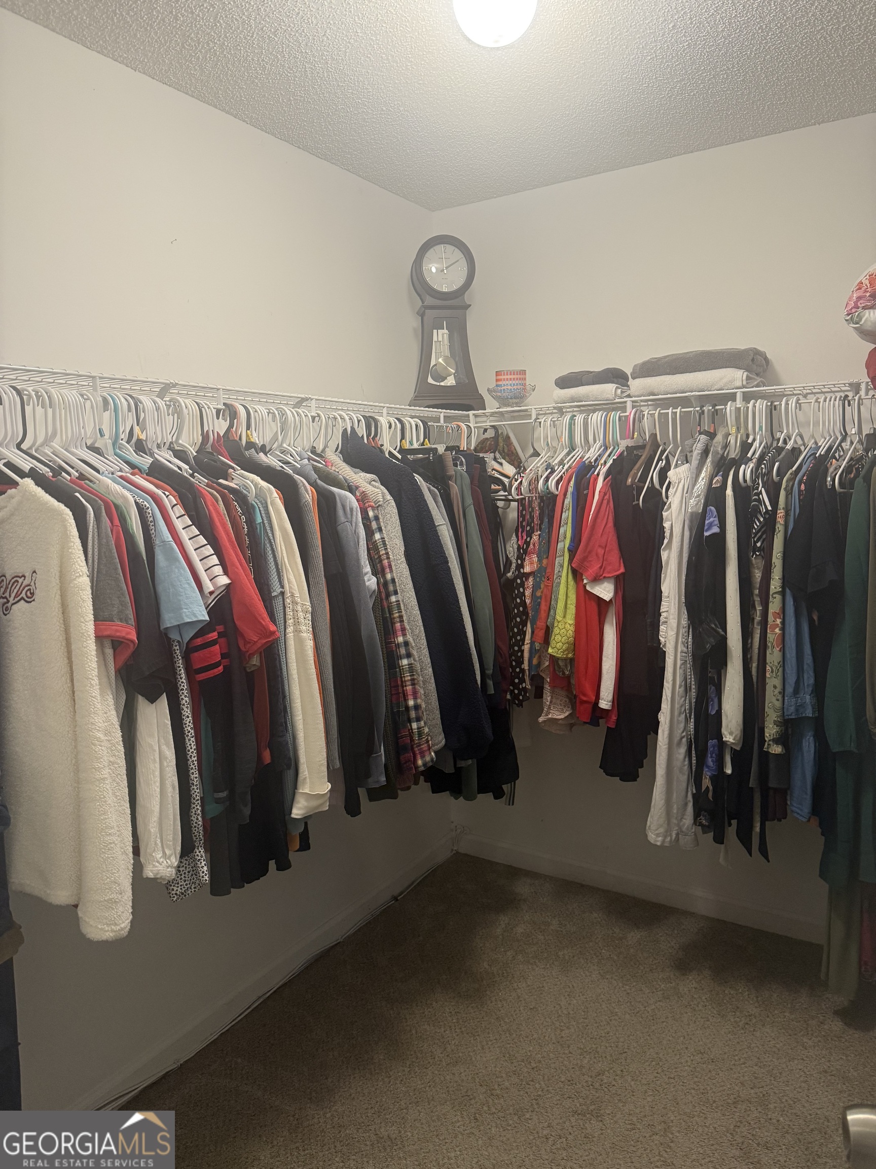 340 Harris Avenue Locust Grove, GA 30248 - Photo 10 of 24 a view of walk in closet with clothes