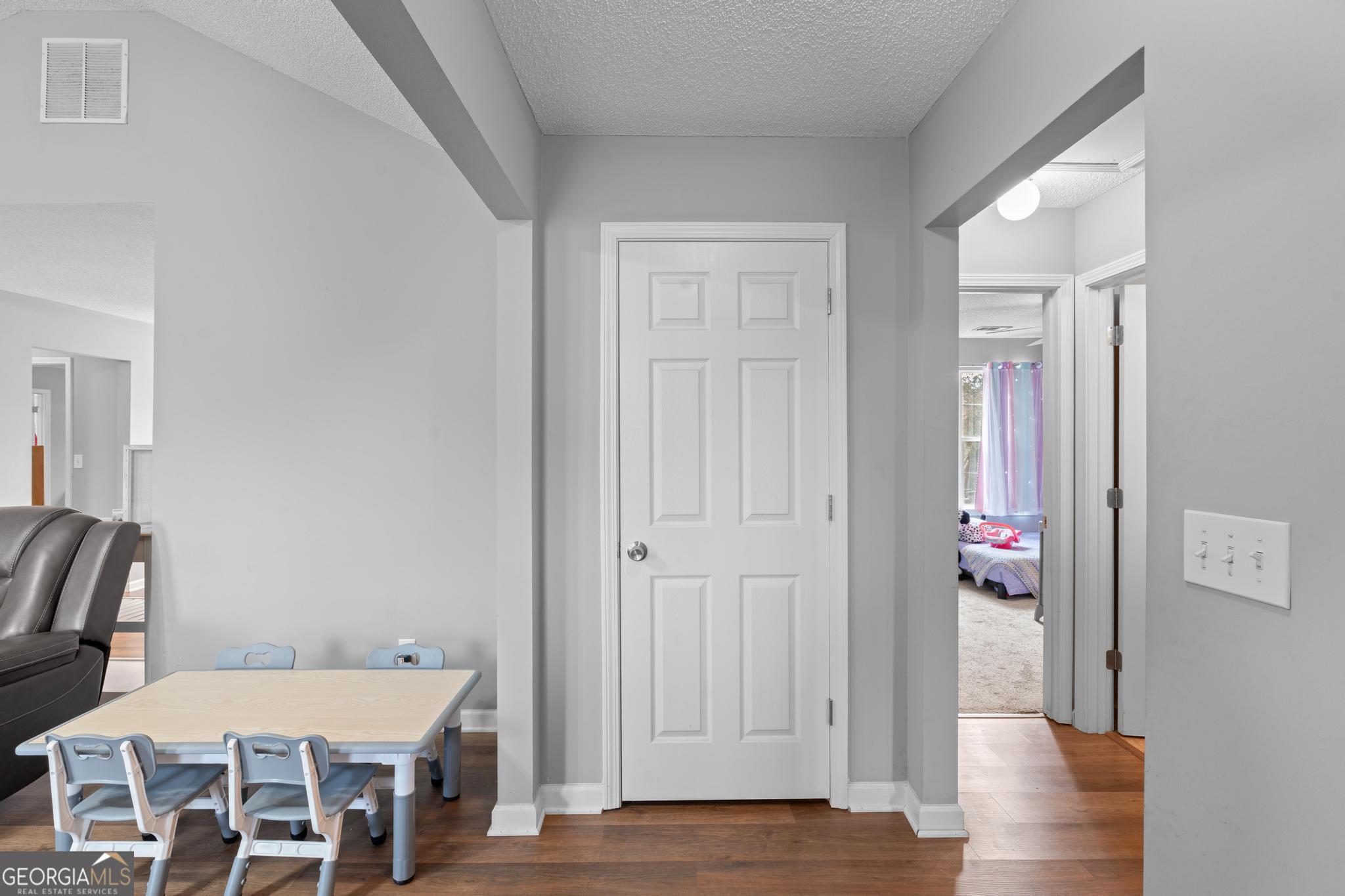 340 Harris Avenue Locust Grove, GA 30248 - Photo 10 of 41 a view of a hallway with furniture and wooden floor