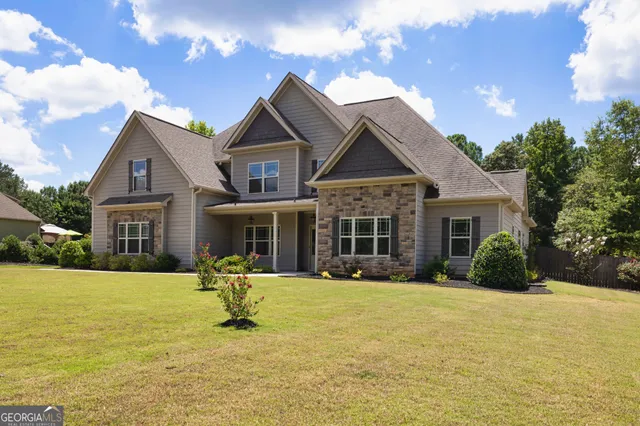 a front view of house with yard outdoor seating and barbeque oven