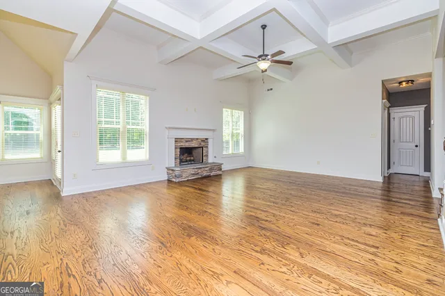 a view of a room with wooden floor and window